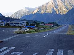 16 02 Planes Land Uphill At Tenzing Hillary Airstrip In Lukla Planes started landing a little after 7am. They hit the upward sloping tarmac, slowed down and turned in to the terminal building. The excited trekkers quickly exited the plane and were encouraged to leave quickly by the whistle-blowing policemen.